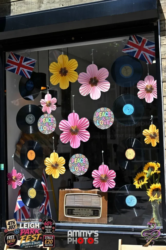 Shop window decorated with vinyl records, colourful flowers and a vintage radio.